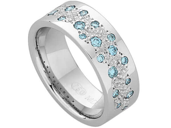 A Random Set Diamond Dress Ring With Light Aqua Blue Diamonds C915 adorned with a stunning aqua blue topaz.