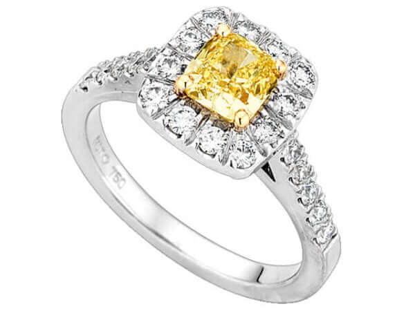 A Fancy Intense Yellow cushion cut halo diamond ring with a halo of diamonds.