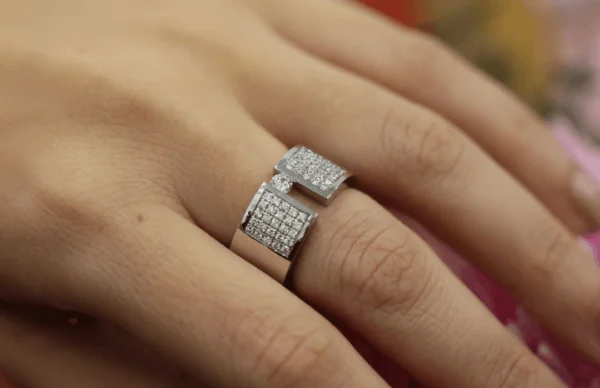 A Wide Tension Set Diamond Ring With Diamond Band C809 adorns a woman's hand.