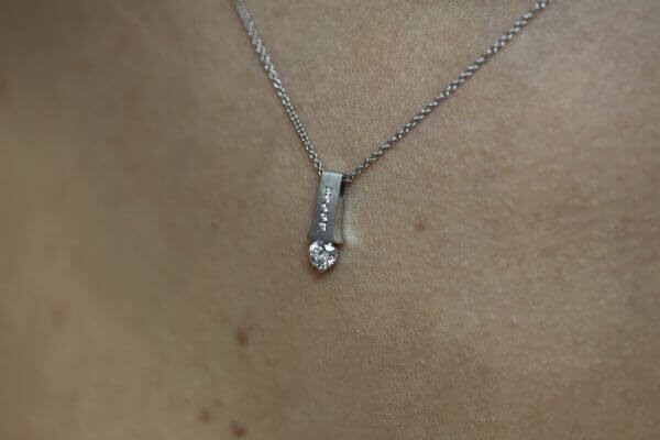 A close up of an Emery C1006 tension set diamond necklace.