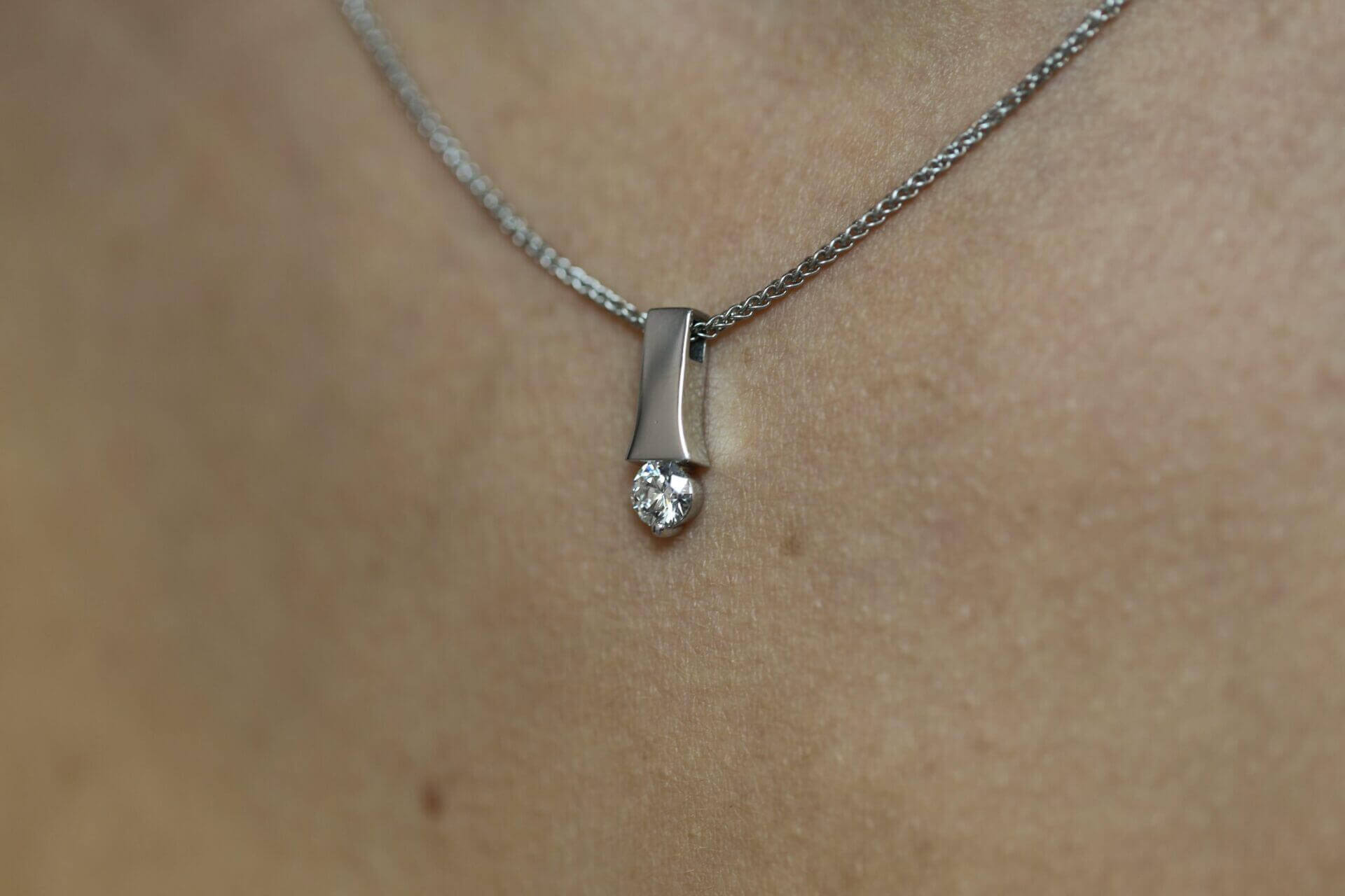 A woman wearing a Tension set diamond necklace C1006.