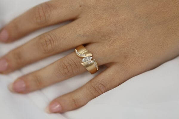 A woman's hand elegantly dons the Rose gold flared tension set engagement ring C746.