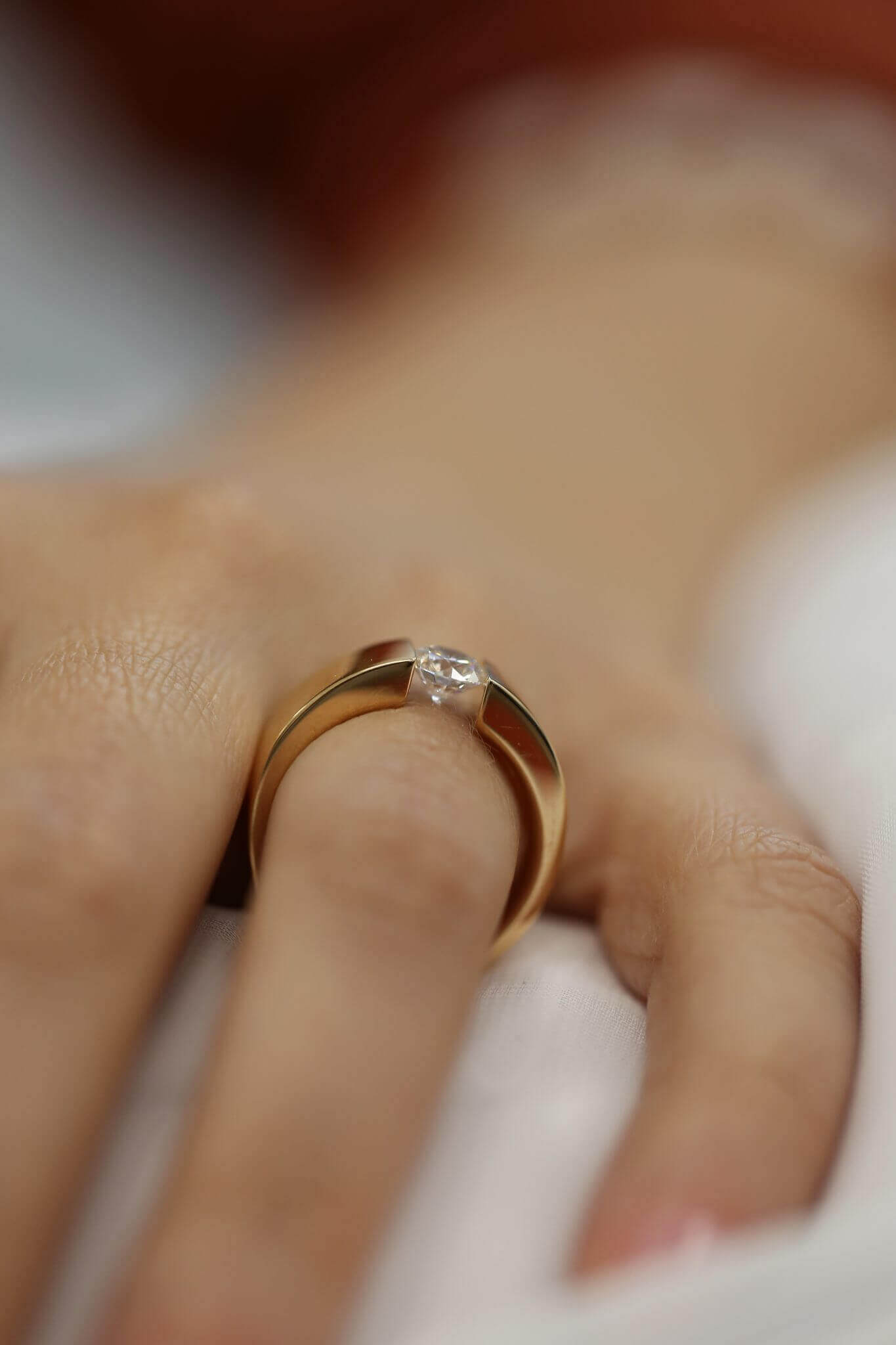 A woman's hand with a Rose Gold Tension Set Ring C364.