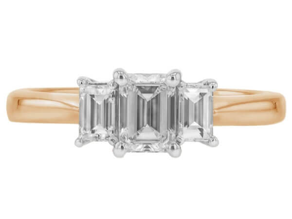 A stunning Diamond Trilogy Engagement Ring with an Emerald cut Diamond and Baguette Sides C321 featuring three emerald cut diamonds set in luxurious 18k yellow gold.