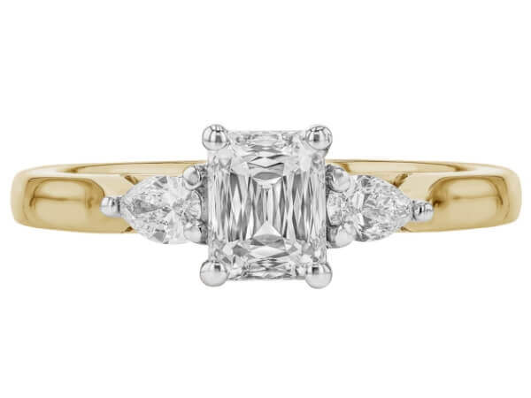 A stunning Emerald Cut Diamond Trilogy Engagement Ring with Pear Shapes C1236 with a yellow gold band.