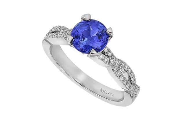 Blue sapphire diamond ring on white background.